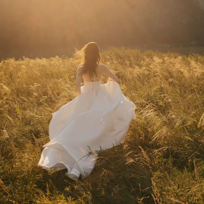 A bride running through a field